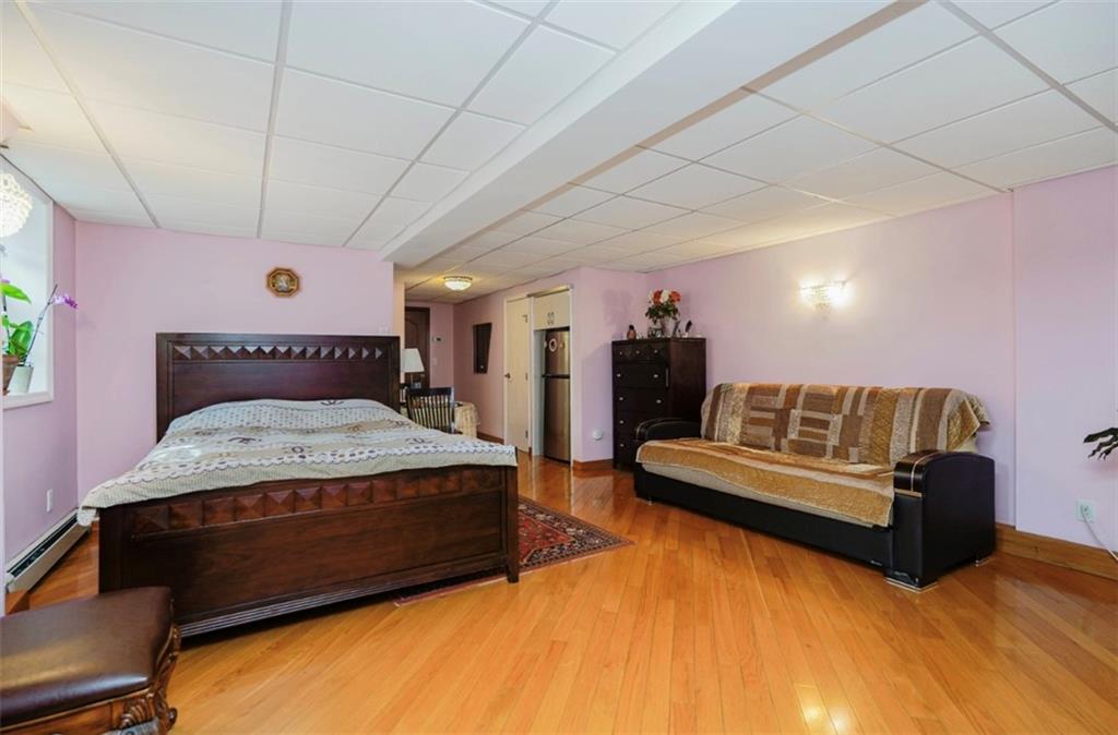 2623 Ave Y Brooklyn, NY 11235 - Photo 26 of 35 a spacious bedroom with a bed mirror and couch