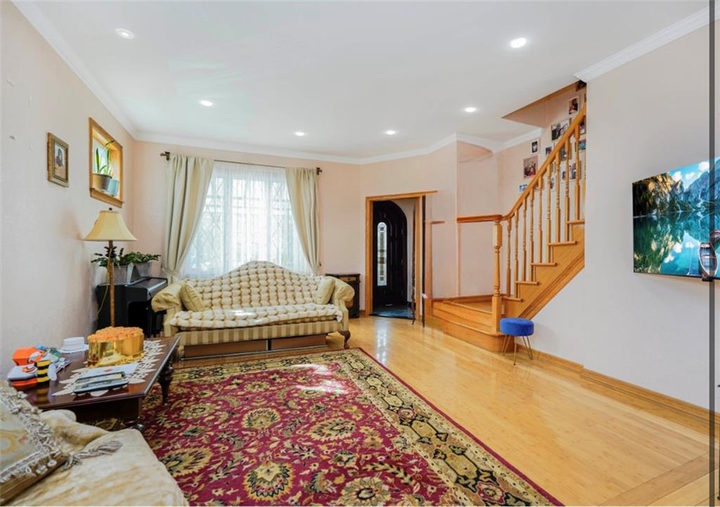 2623 Ave Y Brooklyn, NY 11235 - Photo 5 of 35 a living room with a couch and a rug