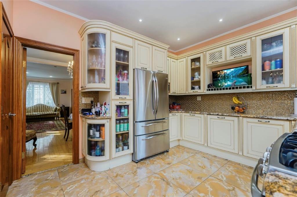 2623 Ave Y Brooklyn, NY 11235 - Photo 8 of 35 a kitchen with stainless steel appliances granite countertop a refrigerator and a stove top oven