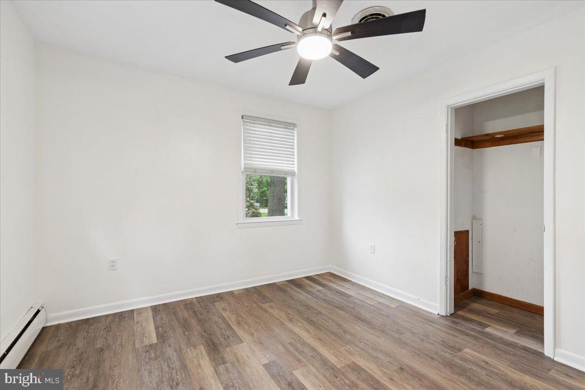 319 Gambrills Road Gambrills, MD 21054 - Photo 25 of 35 an empty room with wooden floor ceiling fan and windows