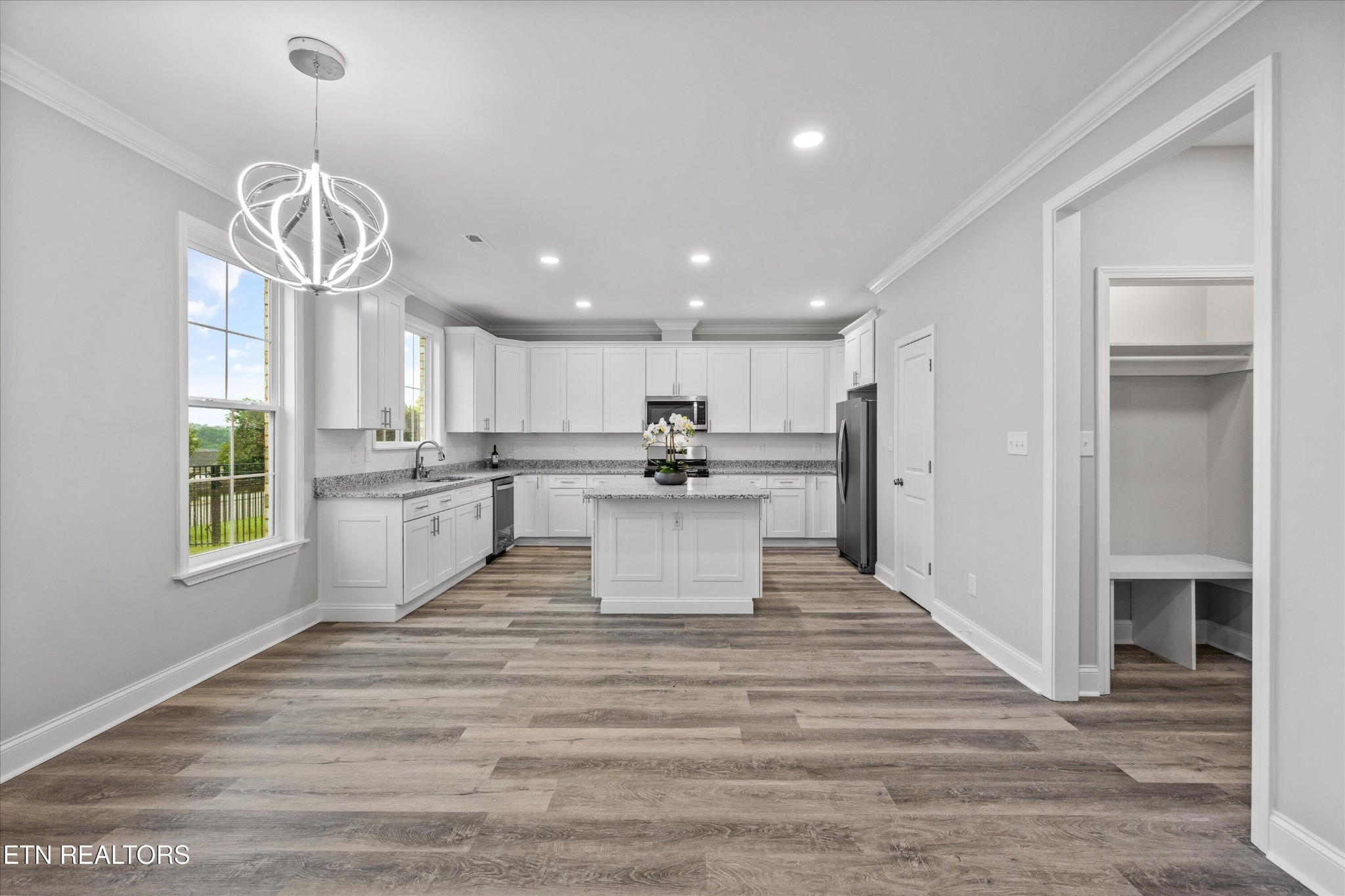 5649 Belle Maison Lane Knoxville, TN 37920 - Photo 11 of 42 a view of a kitchen with kitchen island wooden floor stainless steel appliances and a chandelier
