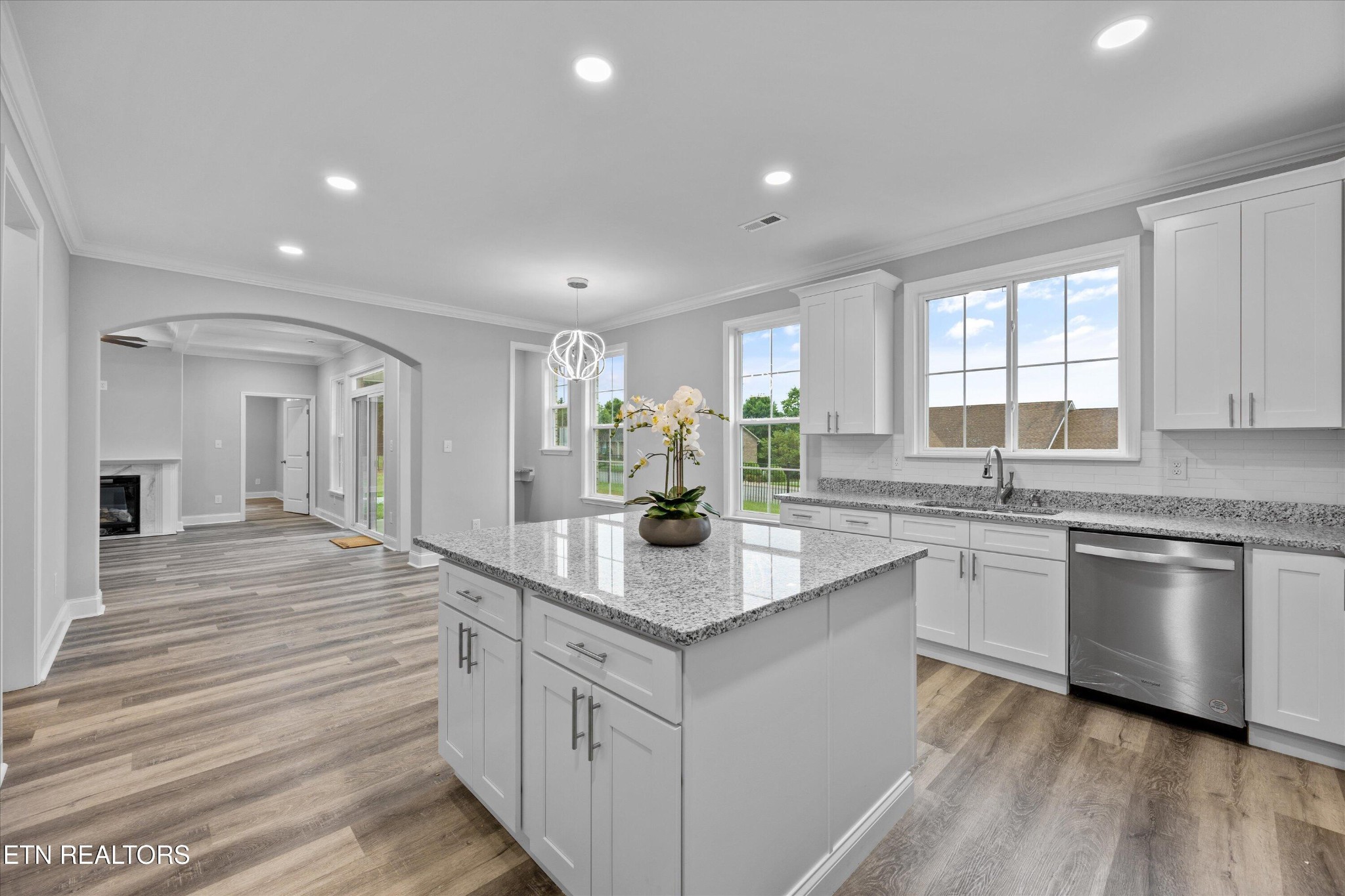 5649 Belle Maison Lane Knoxville, TN 37920 - Photo 14 of 42 a kitchen with kitchen island granite countertop a sink cabinets and wooden floor
