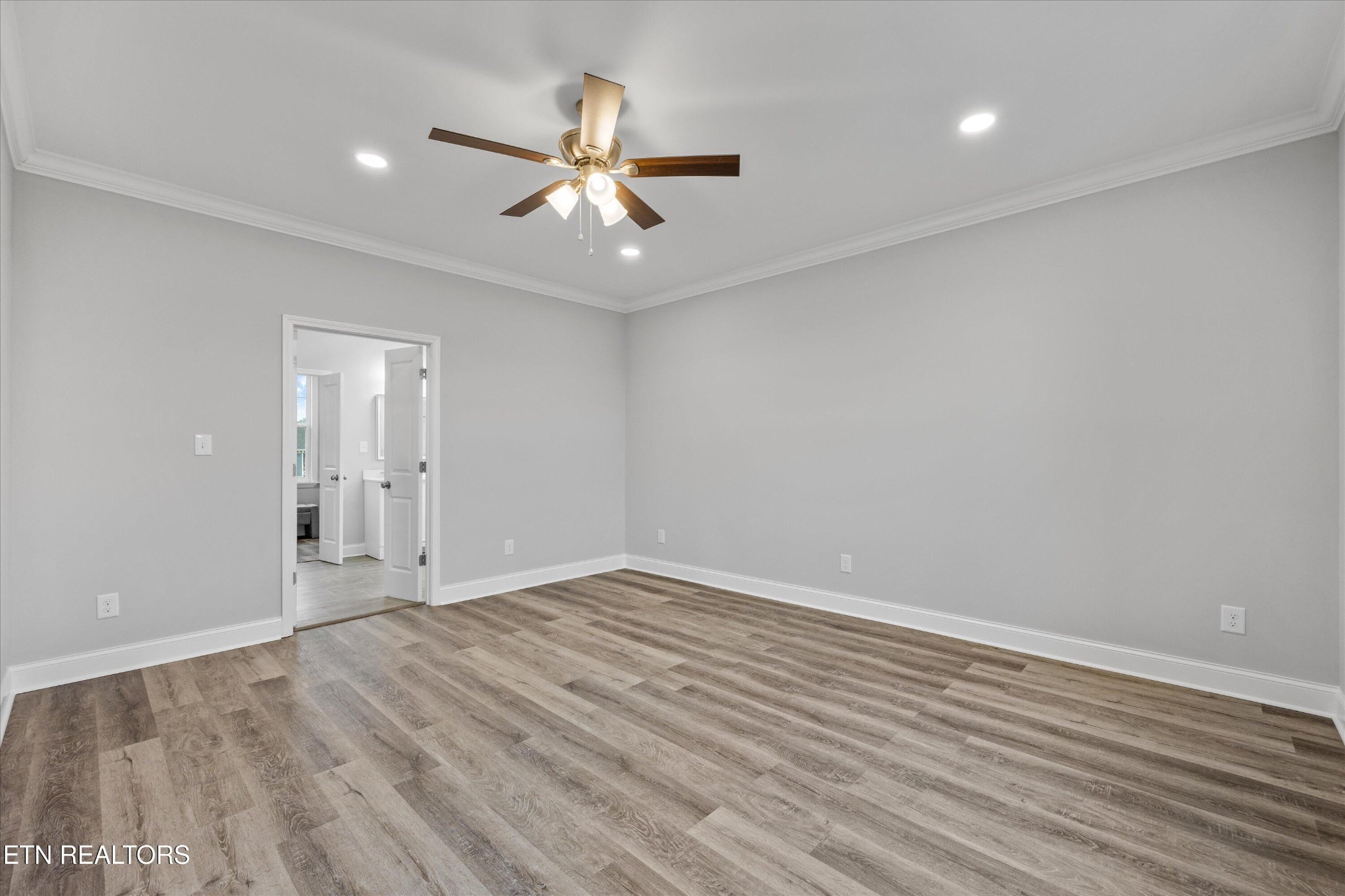 5649 Belle Maison Lane Knoxville, TN 37920 - Photo 17 of 42 a view of an empty room with wooden floor and a ceiling fan