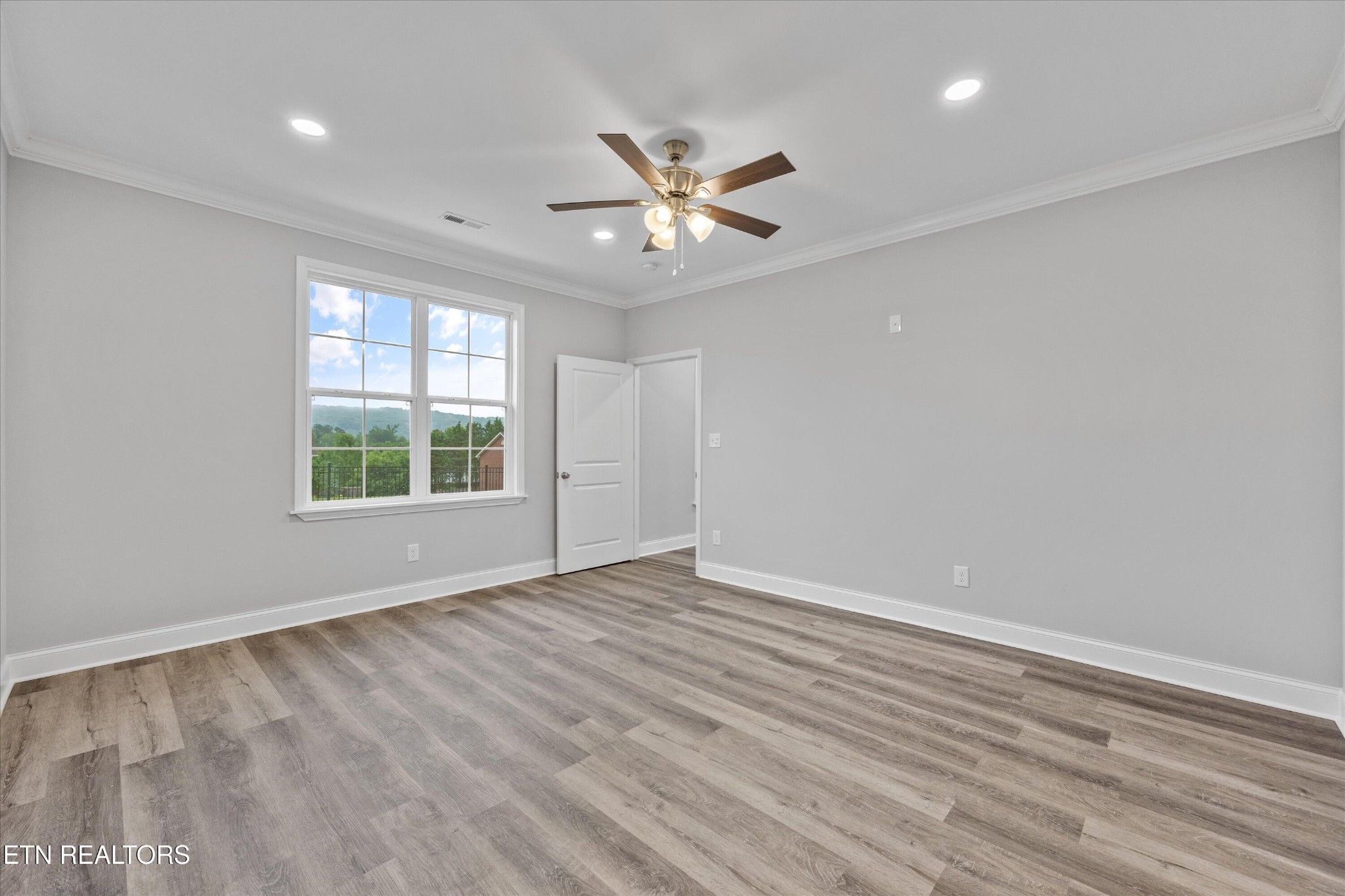 5649 Belle Maison Lane Knoxville, TN 37920 - Photo 18 of 42 wooden floor in an empty room with a window