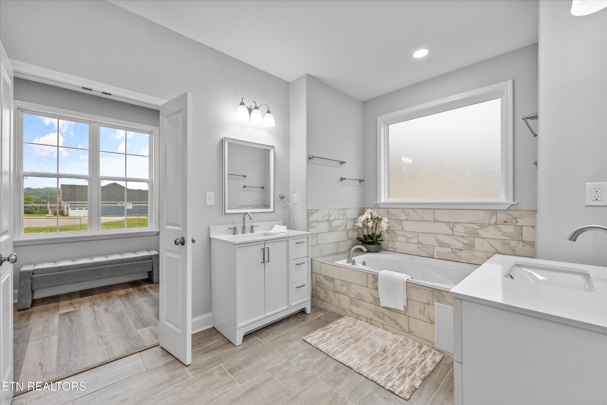 5649 Belle Maison Lane Knoxville, TN 37920 - Photo 19 of 42 a bathroom with a double vanity sink a mirror and a bathtub