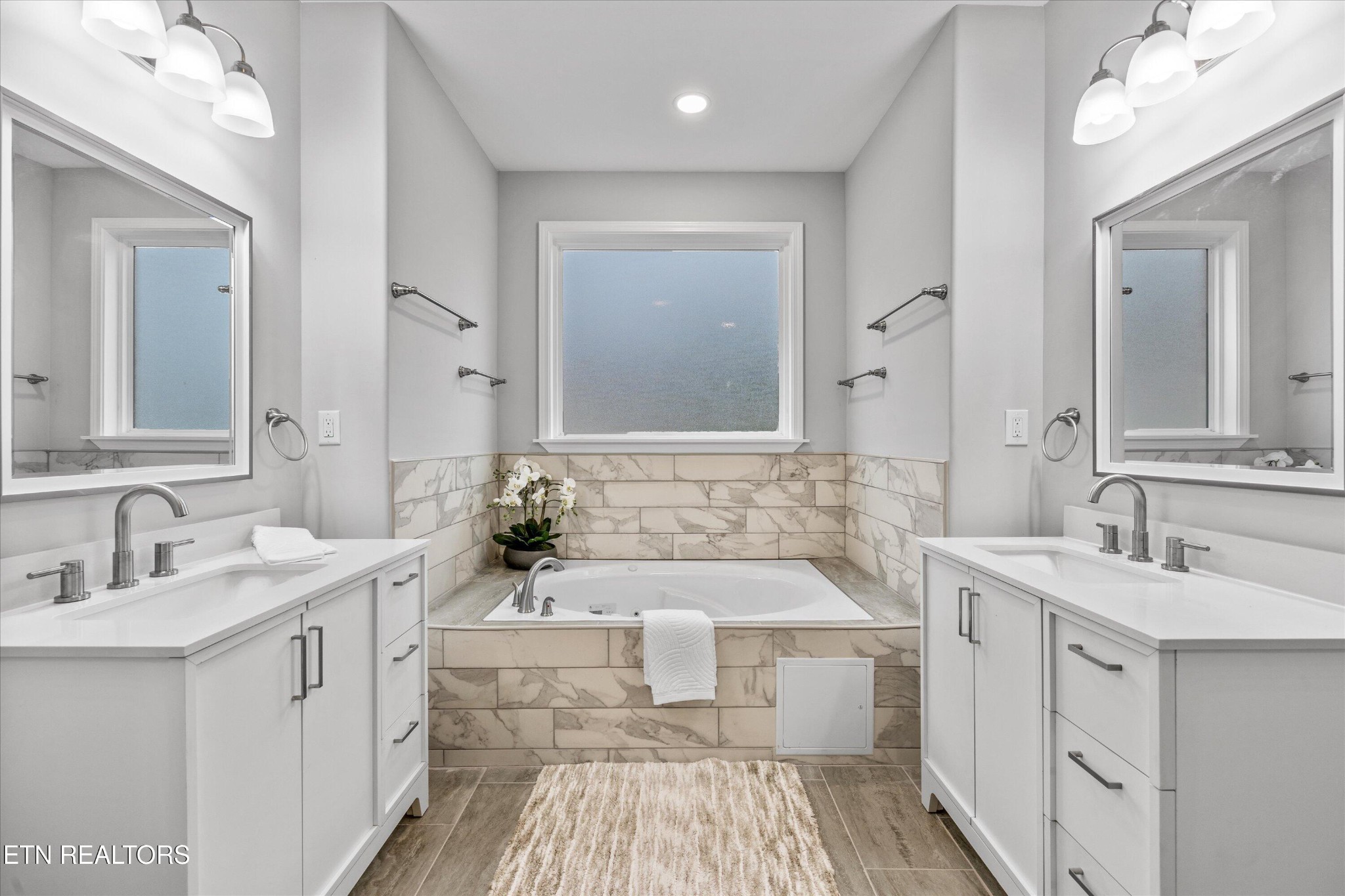 5649 Belle Maison Lane Knoxville, TN 37920 - Photo 20 of 42 a bathroom with a double vanity sink a mirror and a bathtub