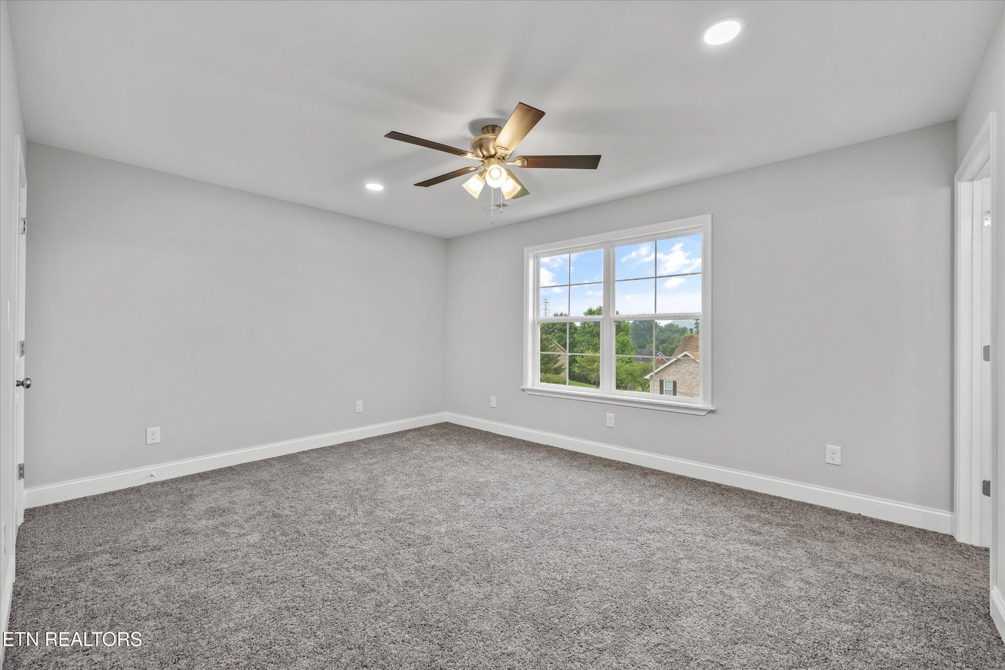 5649 Belle Maison Lane Knoxville, TN 37920 - Photo 29 of 42 an empty room with a window and a fan
