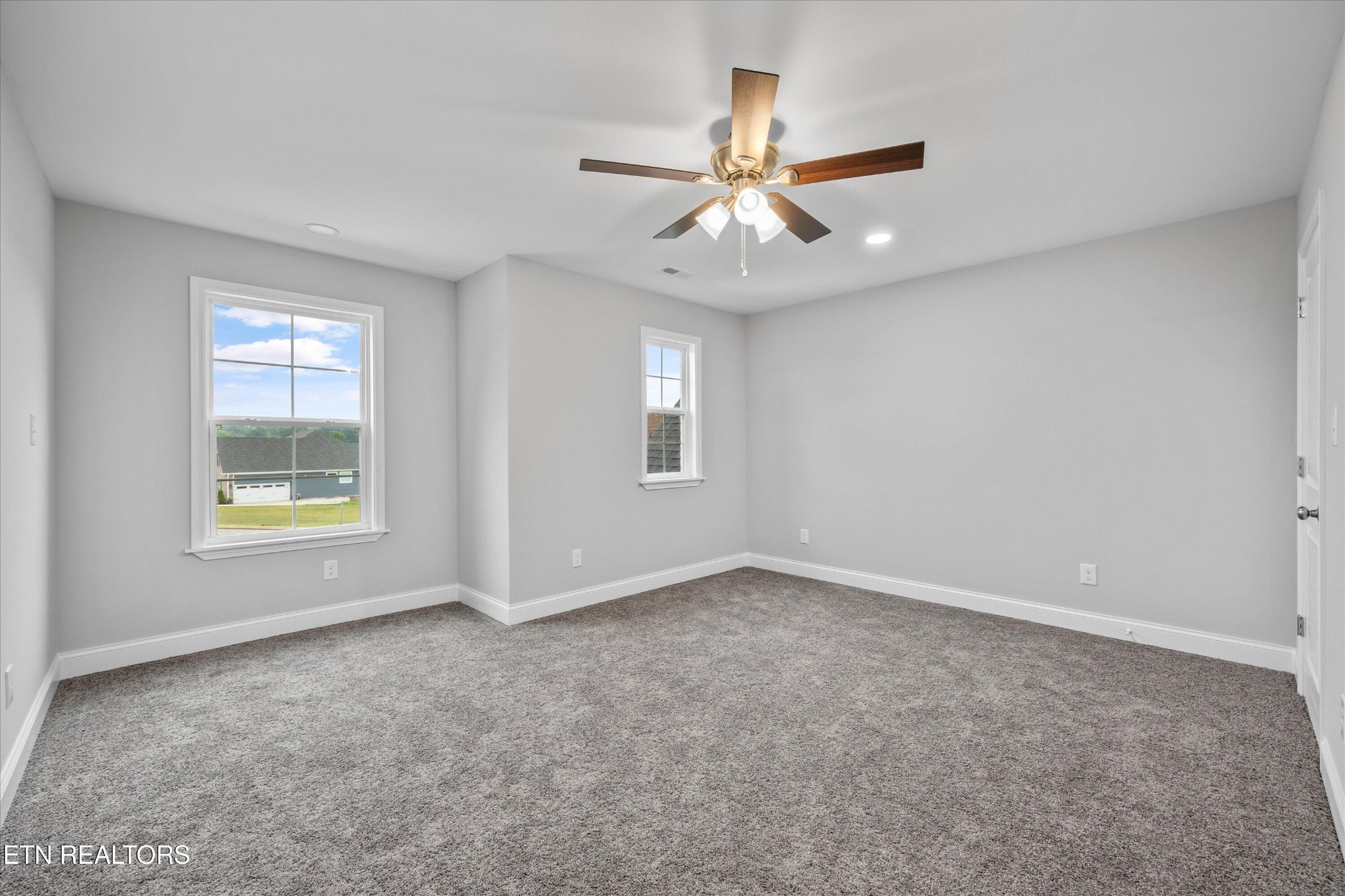 5649 Belle Maison Lane Knoxville, TN 37920 - Photo 31 of 42 an empty room with windows and fan