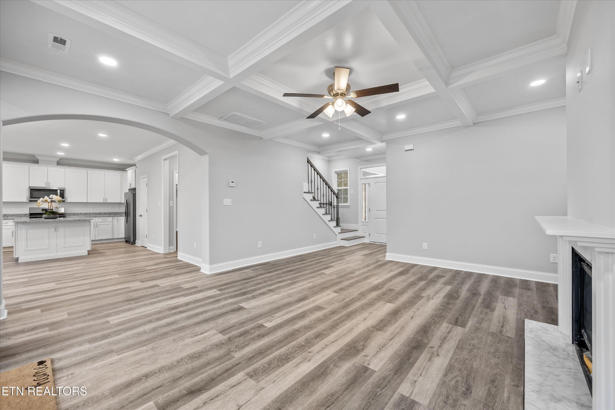 5649 Belle Maison Lane Knoxville, TN 37920 - Photo 9 of 42 a view of an empty room with wooden floor and a ceiling fan