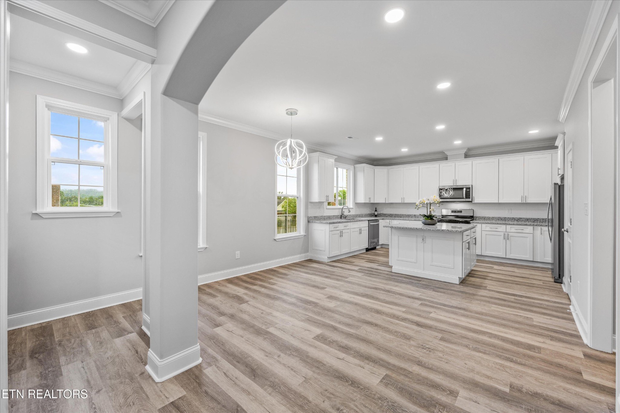 5649 Belle Maison Lane Knoxville, TN 37920 - Photo 10 of 42 a large white kitchen with kitchen island white cabinetry and stainless steel appliances