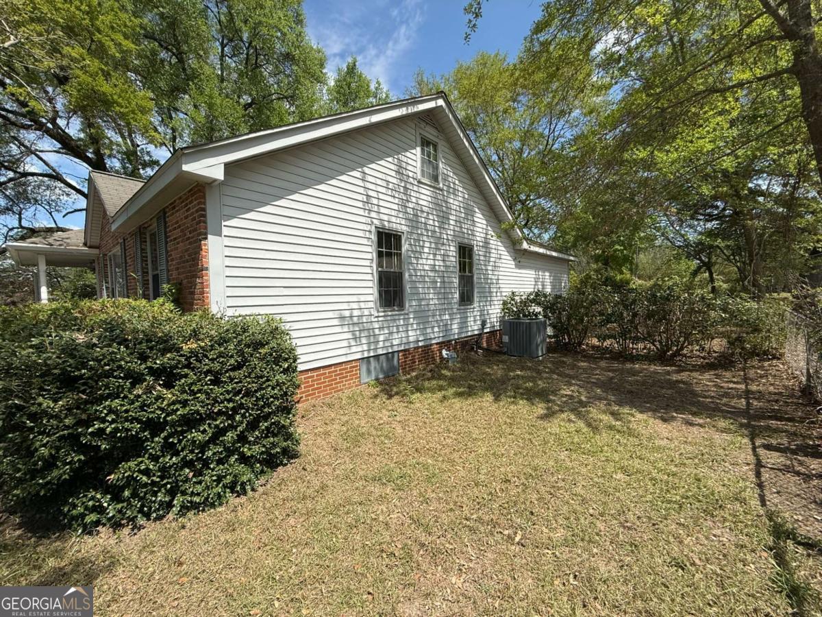 109 Vernon Street Dublin, GA 31021 - Photo 11 of 48 a view of a small house with a yard