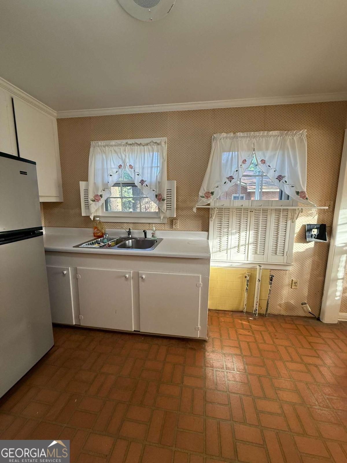 109 Vernon Street Dublin, GA 31021 - Photo 16 of 48 a kitchen with a sink cabinets and window