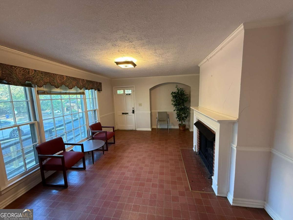 109 Vernon Street Dublin, GA 31021 - Photo 22 of 48 a living room with furniture and a fireplace