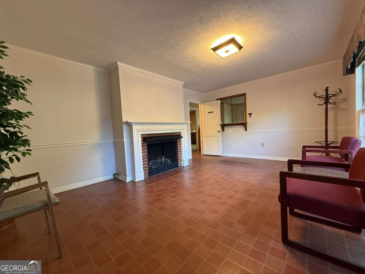 109 Vernon Street Dublin, GA 31021 - Photo 23 of 48 a room with furniture and a fireplace