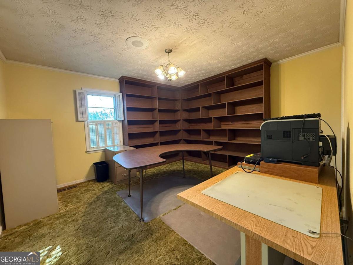109 Vernon Street Dublin, GA 31021 - Photo 30 of 48 a room with furniture a chandelier and a window
