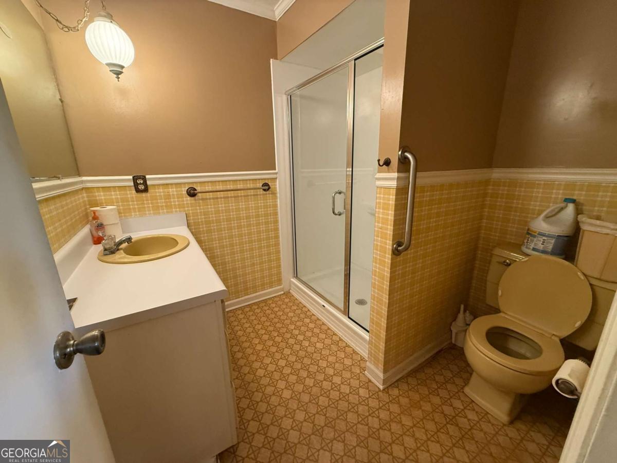 109 Vernon Street Dublin, GA 31021 - Photo 31 of 48 a bathroom with a sink a toilet and shower