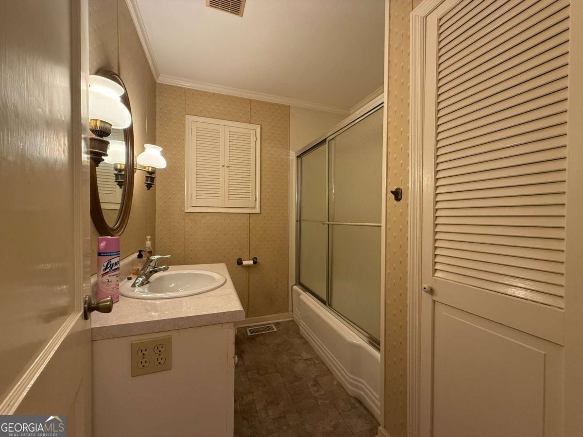 109 Vernon Street Dublin, GA 31021 - Photo 41 of 48 a bathroom with a sink a toilet and a mirror