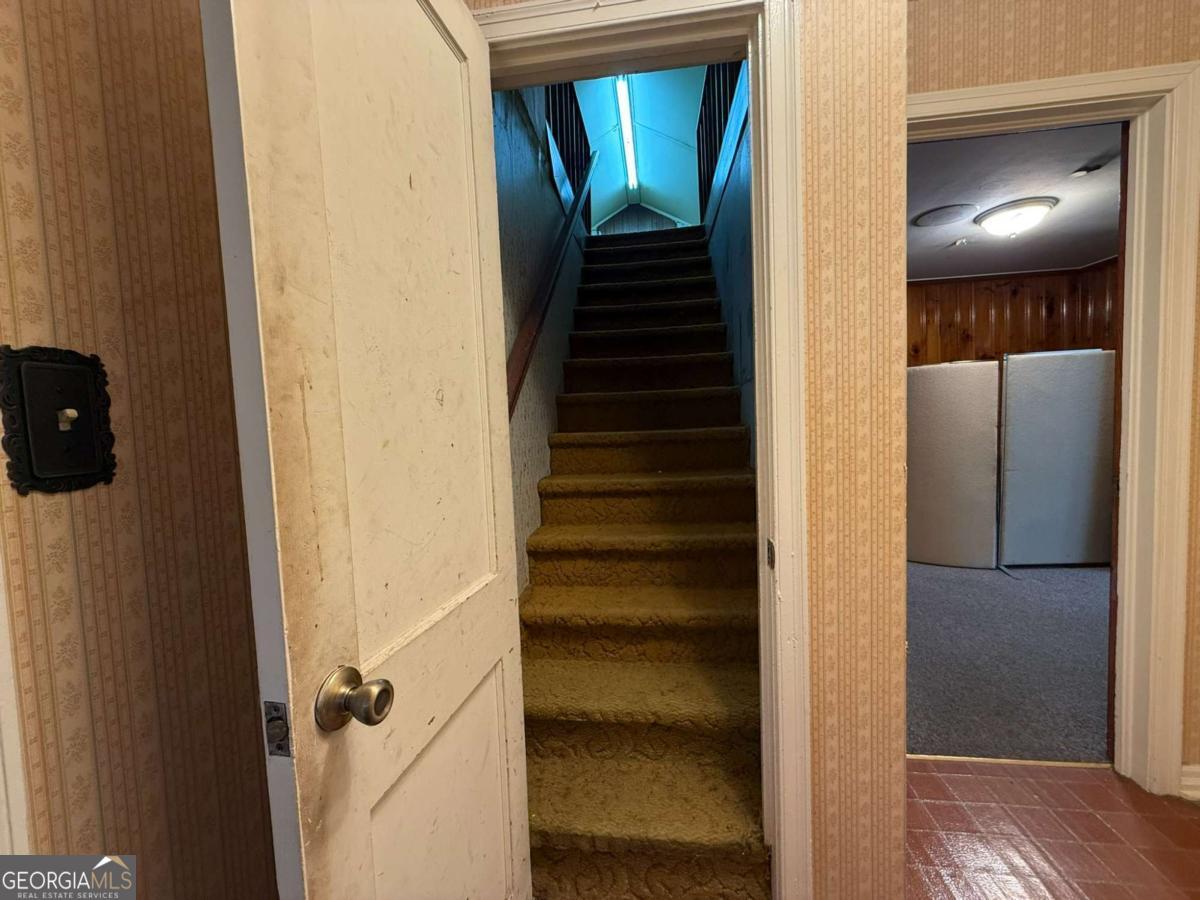 109 Vernon Street Dublin, GA 31021 - Photo 43 of 48 a view of a hallway with wooden floor and staircase