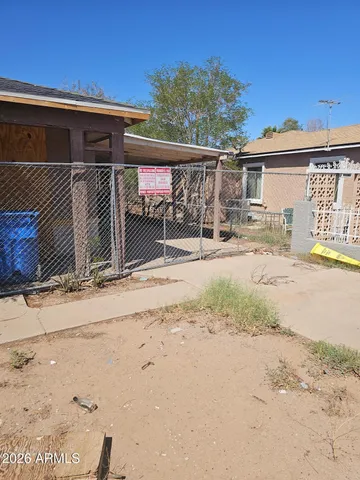 a view of a house with wooden fence