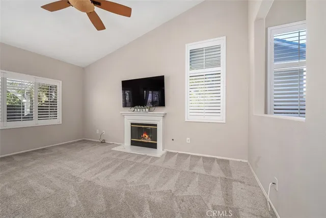 a view of empty room with fireplace and window