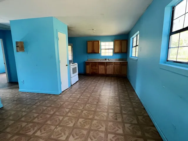 a view of a hallway with a kitchen