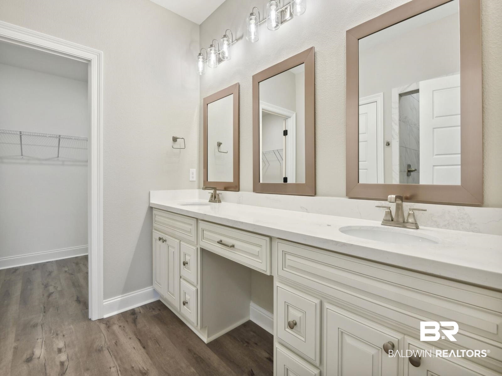 12922 Gondala Street Elberta, AL 36530 - Photo 16 of 20 Full bath with double vanity, a spacious closet, and dark wood-type flooring