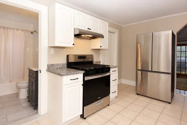 a kitchen with stainless steel appliances a refrigerator sink and stove