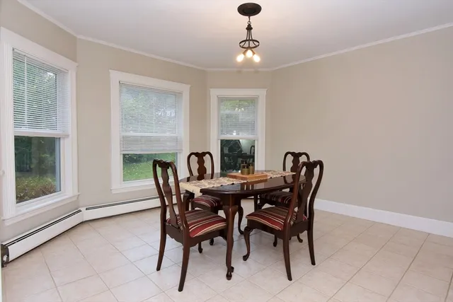 a view of a dining room with furniture and window