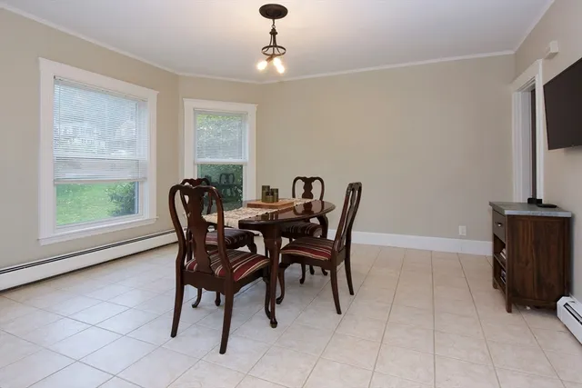 a view of a dining room with furniture and a window