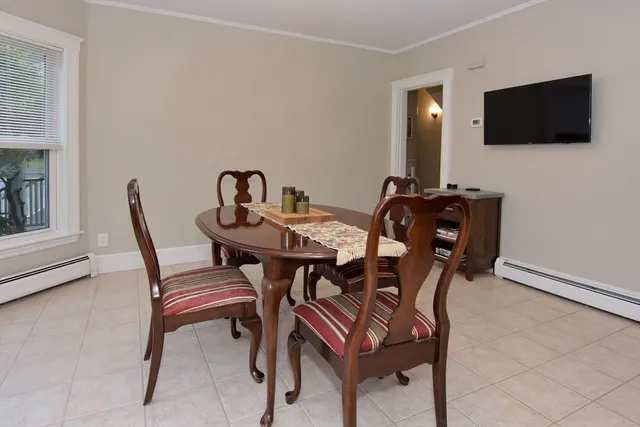 a view of a dining room with furniture and a flat screen tv