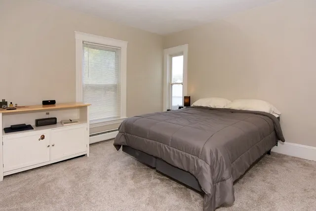 a bedroom with a bed and window