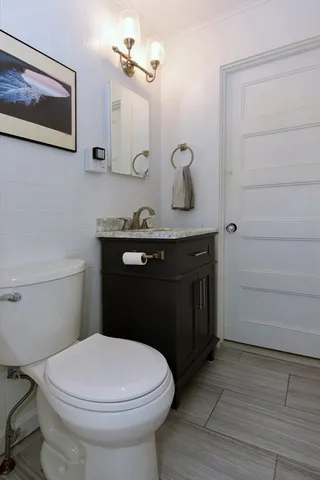 a bathroom with a sink a toilet and mirror
