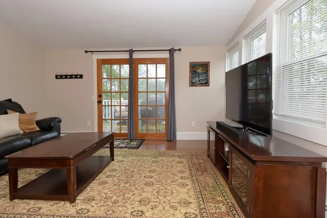 a bedroom with furniture and a flat screen tv