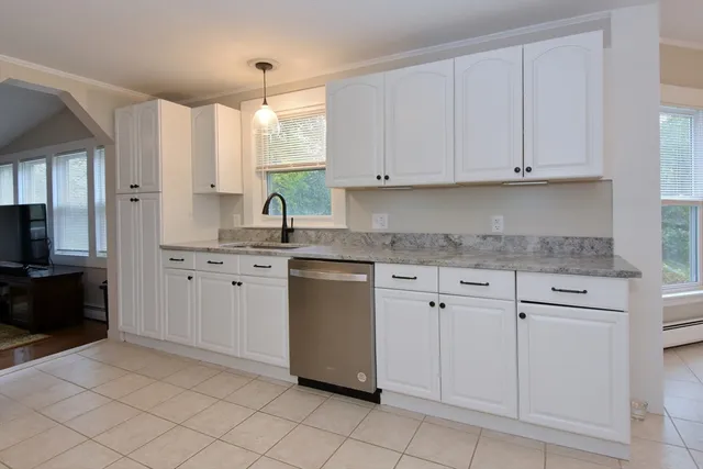 a kitchen with white cabinets and a sink