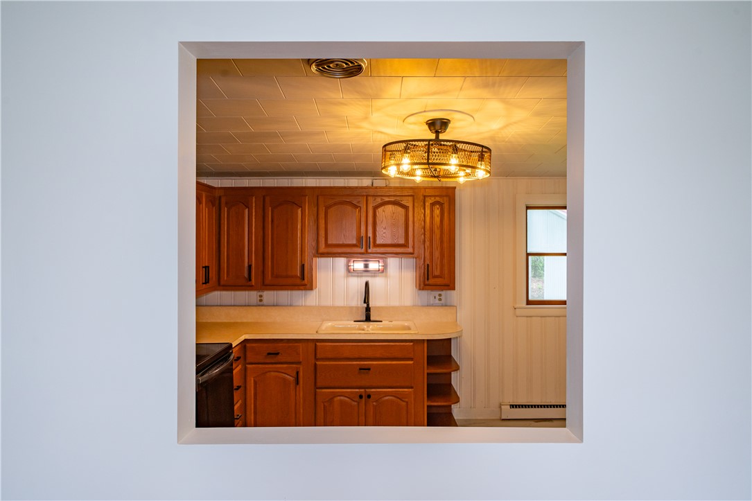 11296 Pansing Road Brookville, OH 45309 - Photo 14 of 53 This kitchen features classic cabinetry, offering ample storage and a functional layout for daily living.