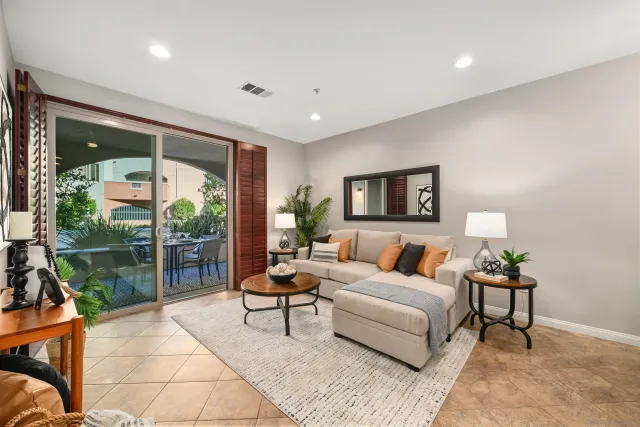 a living room with furniture and a floor to ceiling window