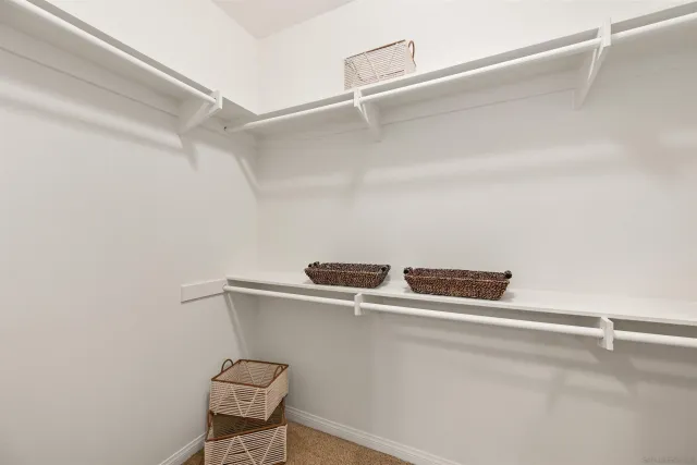 a bathroom with a granite countertop sink a mirror and a shower