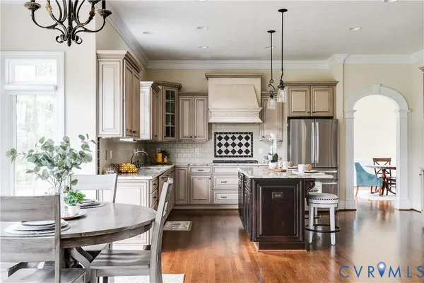 a kitchen with granite countertop a sink stove and cabinets