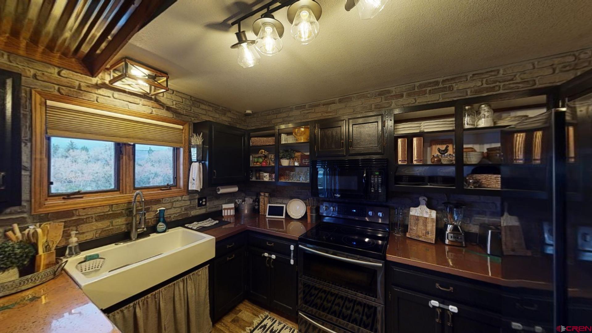 18377 Highway 65 Cedaredge, CO 81413 - Photo 12 of 35 a kitchen with sink a stove and cabinets
