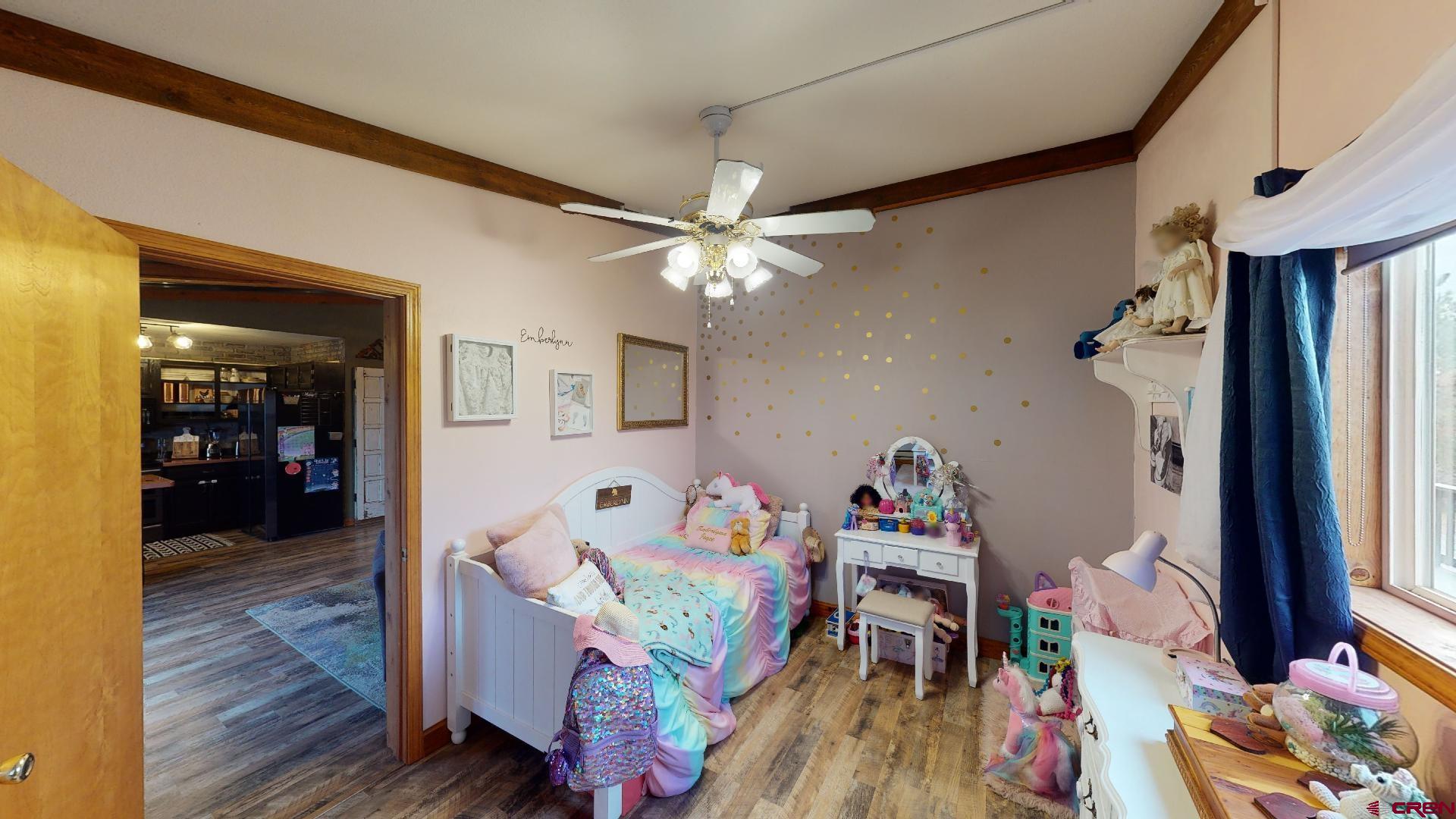 18377 Highway 65 Cedaredge, CO 81413 - Photo 19 of 35 a bedroom with furniture and a wooden floor