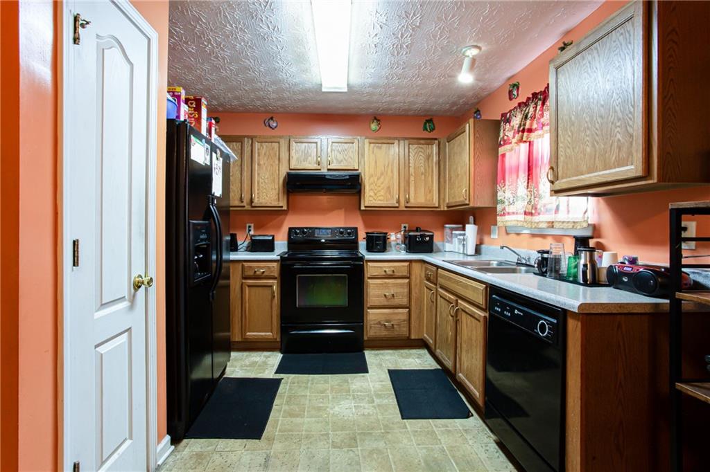 690 Georgetown Lane Jonesboro, GA 30236 - Photo 13 of 30 a kitchen with stainless steel appliances granite countertop a refrigerator and a sink