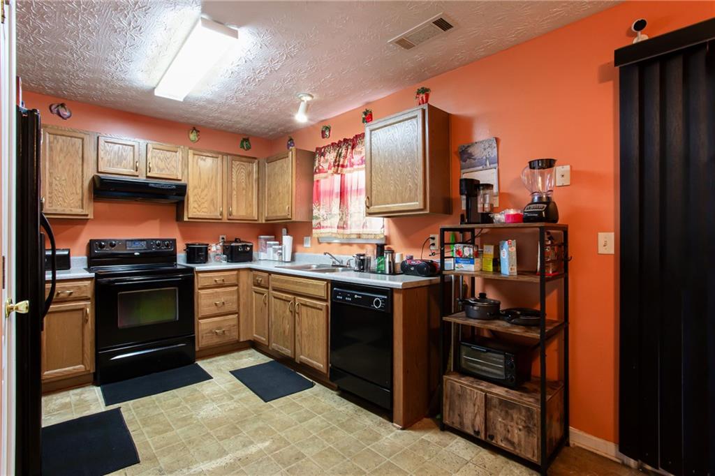 690 Georgetown Lane Jonesboro, GA 30236 - Photo 14 of 30 a kitchen with stainless steel appliances a stove and a refrigerator