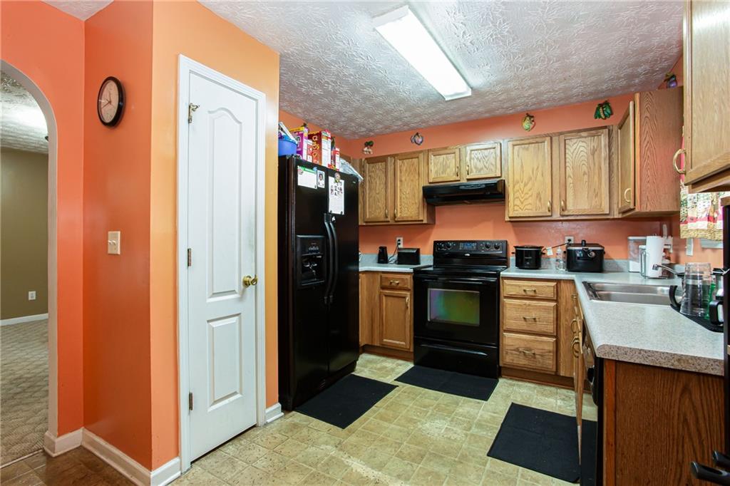 690 Georgetown Lane Jonesboro, GA 30236 - Photo 15 of 30 a kitchen with granite countertop stainless steel appliances and counter space