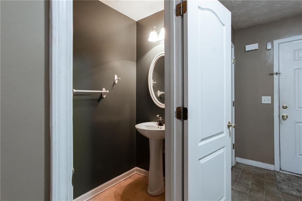 690 Georgetown Lane Jonesboro, GA 30236 - Photo 18 of 30 a bathroom with a light fixture and a mirror