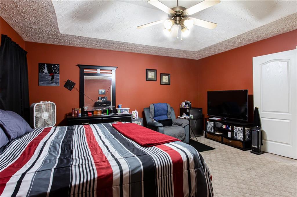 690 Georgetown Lane Jonesboro, GA 30236 - Photo 21 of 30 a bedroom with bed and a flat tv screen on dresser