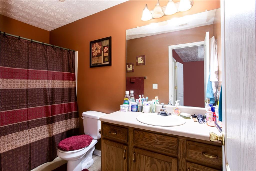 690 Georgetown Lane Jonesboro, GA 30236 - Photo 24 of 30 a bathroom with a sink toilet and shower