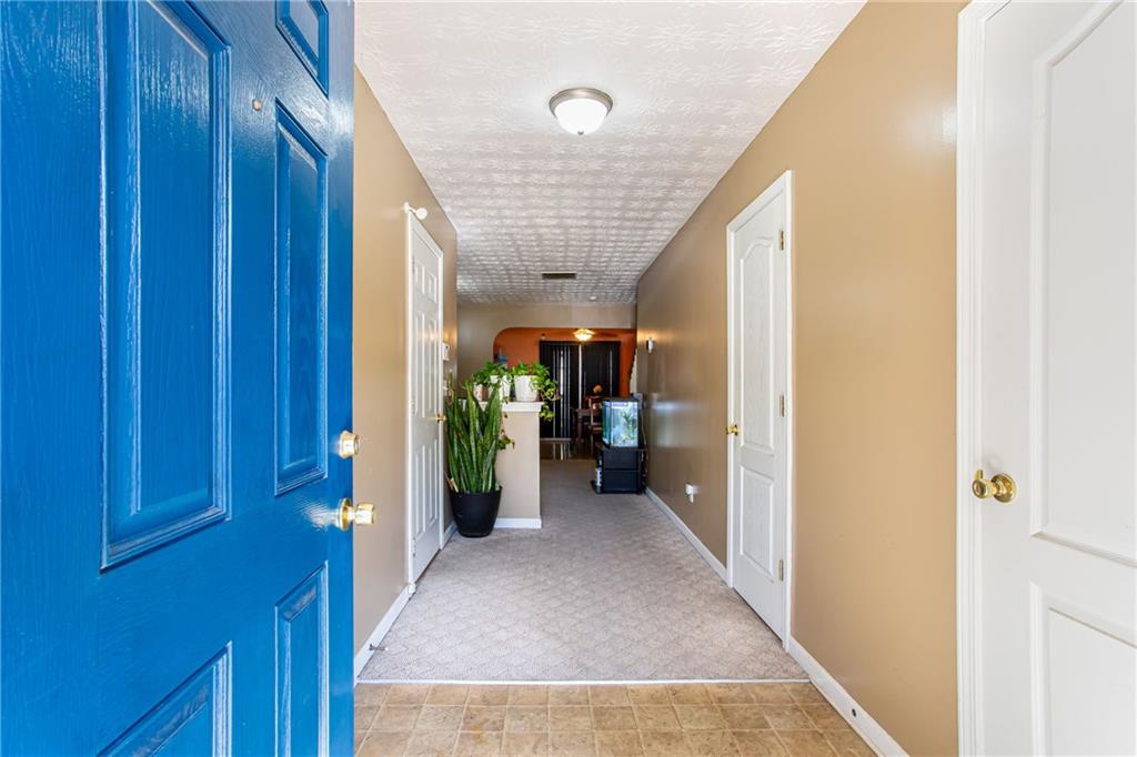 690 Georgetown Lane Jonesboro, GA 30236 - Photo 7 of 30 a view of a hallway with wooden shelves
