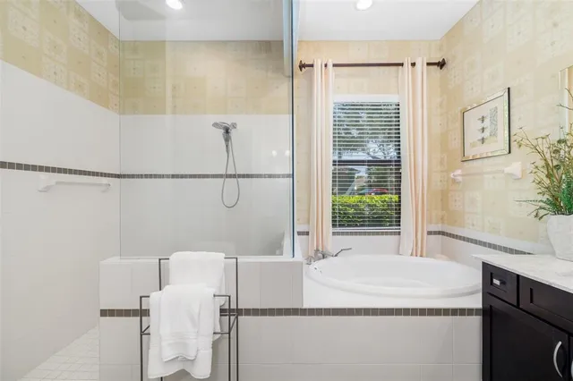 a bathroom with a granite countertop sink a toilet a mirror and shower