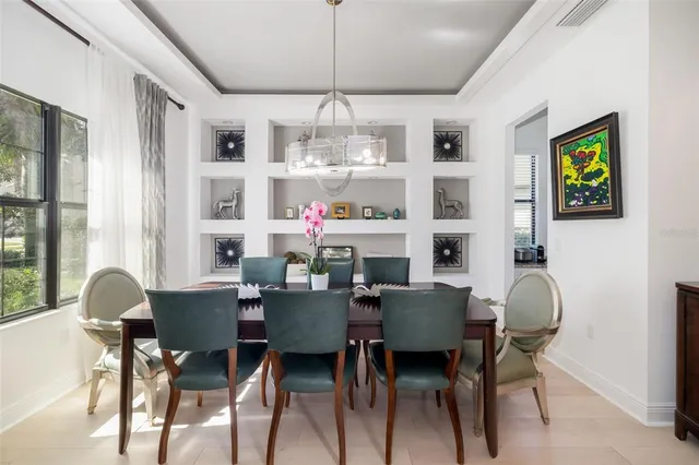 a kitchen with stainless steel appliances kitchen island granite countertop a table and chairs in it