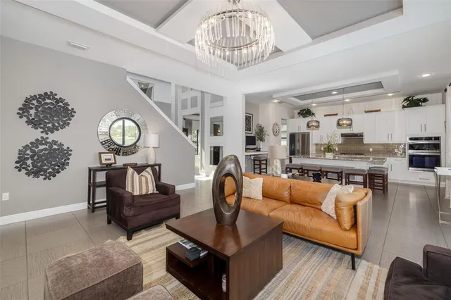 a living room with granite countertop furniture and a wooden floor